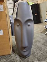 Front view of grey matte ceramic face vase
