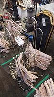 Multiple bundles of wood hangers stacked on chrome racks