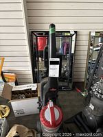 Front view upright vacuum red top clear canister
