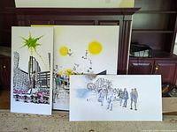 All three paintings leaning against cabinet