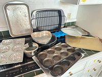Overview of assorted bakeware and cookware on stovetop