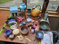 Overview showing majority of ceramic pieces, figurines and decor on table