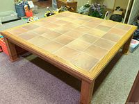 Full view of square oak coffee table with tile top
