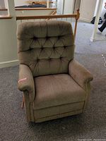 Front view of brown fabric La-Z-Boy recliner chair showing tufted back and arms