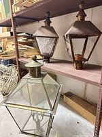 Three lanterns on shelving