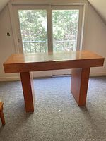 Front view of light cherry wood altar console table