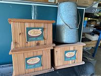 Three cedar planter boxes stacked with galvanized bucket