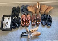 All nine pairs arranged on floor plus shoe trees