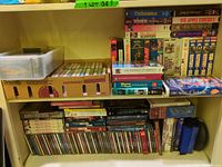 Overall shelf view showing VHS tapes, CDs, cassettes