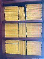Front view of three shelves filled with yellow-border National Geographic magazines