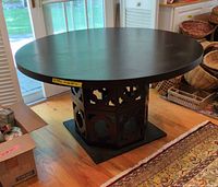 Full view of round black dining table in room