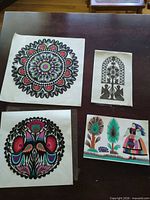 Group photo of all four paper cuts on table