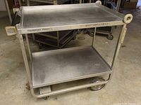 Full view of stainless steel two-shelf cart with wheels