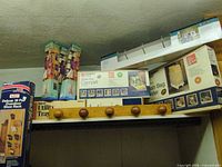 All items on shelf: wood coat rack, slide-out tray box, bag holder box, Magic Holder boxes, overdoor shoe rack box