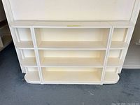 Front view of white bookcase showing shelves and curved ends