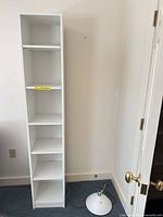 Full front view of tall white bookcase
