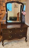 Front view showing dresser, drawers, mirror, hardware