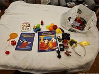 Full lot layout on sheet showing books, cars, figures, play food and bag of toys