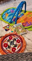 Overall lot: play gym, cloth books, hardcover book, embroidered mat