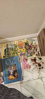 Lot overview showing all books, toys, and wand on floor