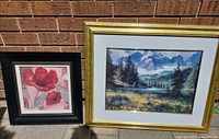 Both framed prints side by side against brick wall