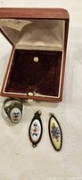 ring and two pendants inside open presentation box