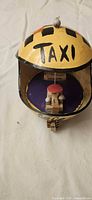 Top view showing TAXI lettering on yellow coconut shell dome and interior details