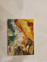 Front view of miniature abstract mixed media painting on wood panel