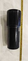 Side view of full lens beside ruler