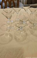 Overview of all seven clear glass stemware pieces on table