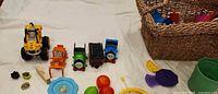 overview of toys and basket on cloth