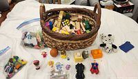 Full lot showing basket, blocks, bags, figures, plush dog, bean bag