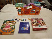 Group shot of playset, books, puzzle and accessories laid out on surface