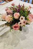 Full view of artificial flower arrangement showing variety of blooms and foliage