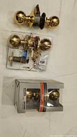 All three packages of door knob sets displayed