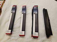 Three boxed ProAuto shades and one unboxed showing roller