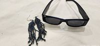 Sunglasses and earrings top view