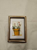 Framed print showing artwork, gold frame, white mat