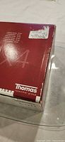 outer packaging corner showing Thomas branding and box damage