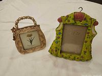 Front view of purse and dress frames standing upright