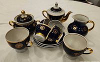 full tea set grouped, showing all pieces and pattern