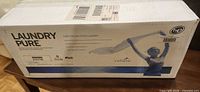 Sealed shipping box showing LaundryPure branding and HE compatibility