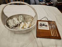 Full lot showing basket with mugs, cheese board with knives