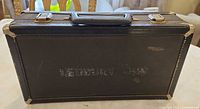 Front exterior of black hard clarinet case with handle, latches and corner protectors