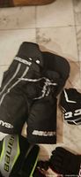 Bauer hockey pants and Bauer glove visible