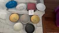 Overhead view of all nine bowls and dishes displayed on marble surface
