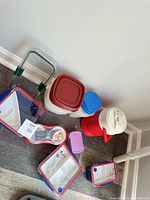 Group view of plastic containers, lunchboxes and insulated jug