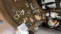 Full view of assorted earrings spread on table