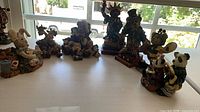 Group shot of all seven resin figurines on tabletop