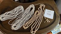 All necklaces and earrings arranged on tray